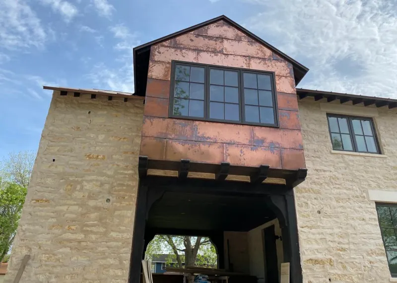 Copper metal panel facade on a stone building for Skylight Installation in Thomasville